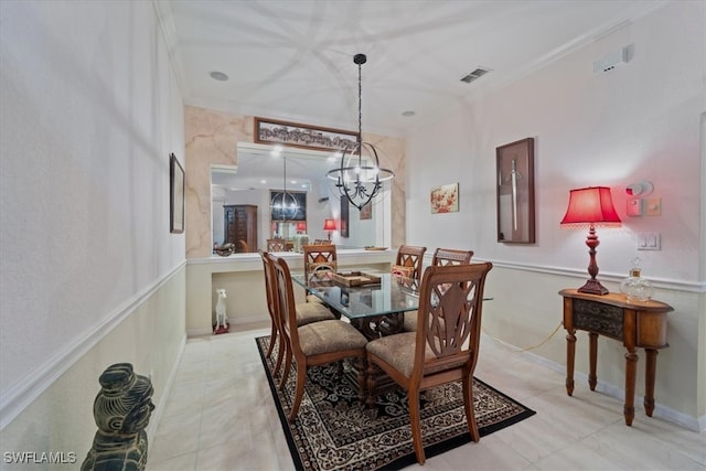 dining area with an inviting chandelier and ornamental molding