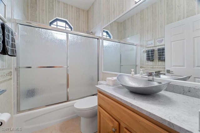 full bathroom featuring shower / bath combination with glass door, vanity, and toilet