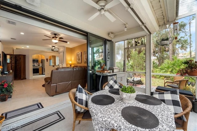 sunroom / solarium featuring ceiling fan