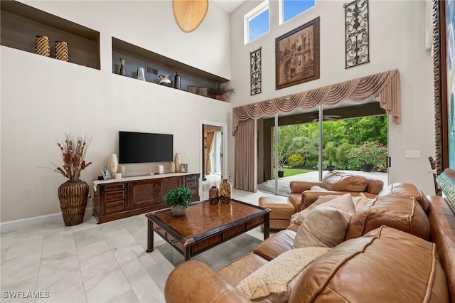 living room with a towering ceiling and a wealth of natural light