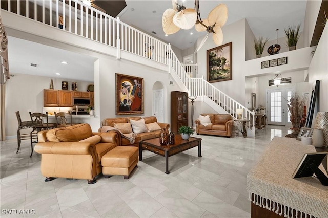 living room featuring a towering ceiling and french doors