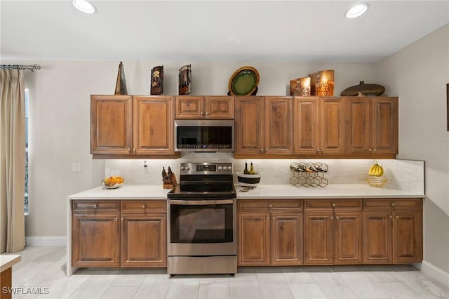 kitchen featuring appliances with stainless steel finishes and tasteful backsplash