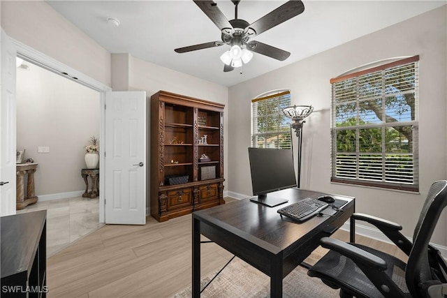 office area with light hardwood / wood-style floors and ceiling fan