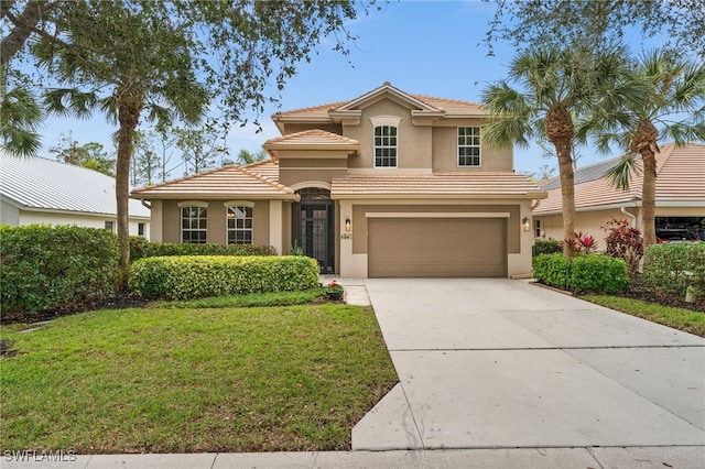 mediterranean / spanish house featuring a garage and a front lawn