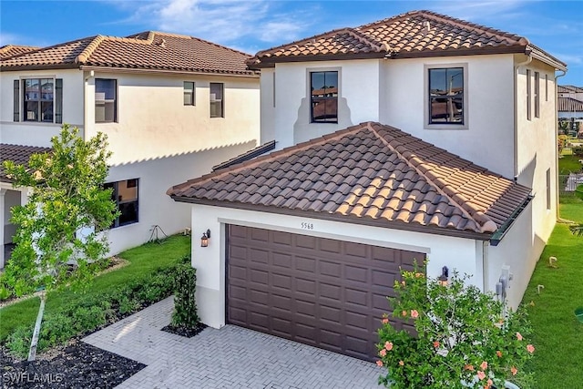 mediterranean / spanish-style house featuring a garage