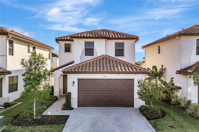 mediterranean / spanish home with a garage