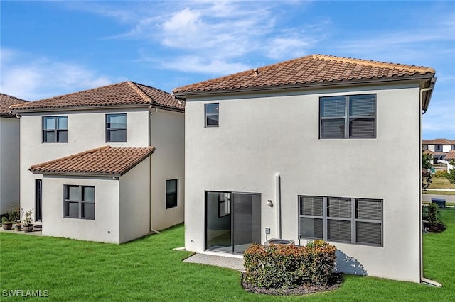 rear view of house featuring a yard