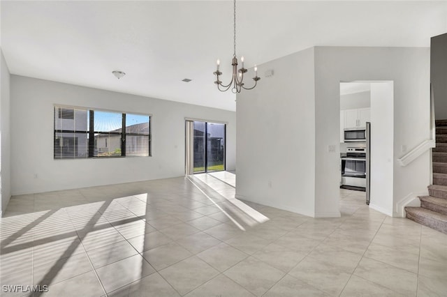 unfurnished room featuring an inviting chandelier and light tile patterned floors