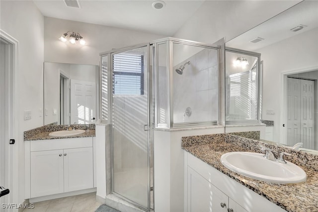 bathroom with vanity, walk in shower, and tile patterned floors