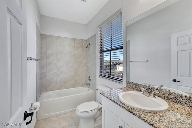 full bathroom featuring vanity, tiled shower / bath combo, tile patterned floors, and toilet