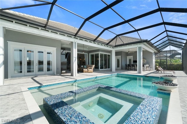 back of house with french doors, a patio area, a lanai, a bar, and ceiling fan