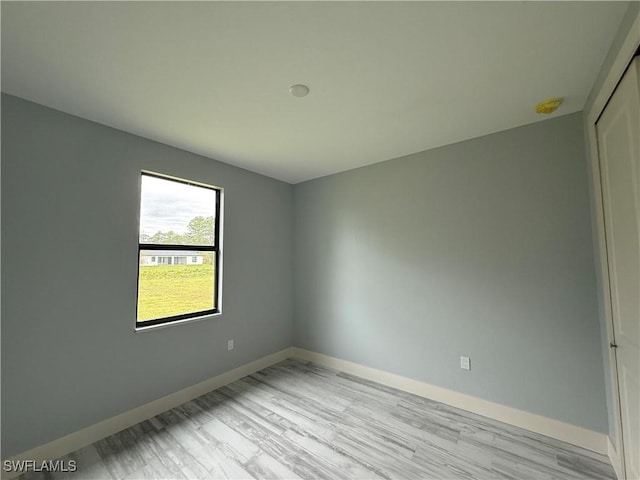 unfurnished room with light wood-type flooring