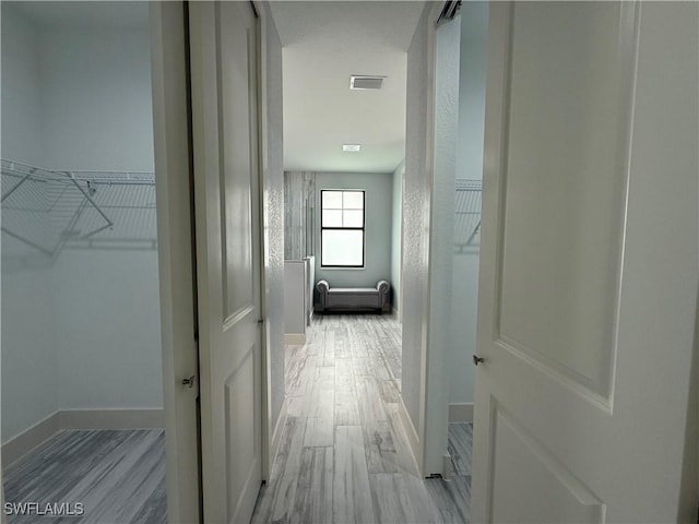 corridor with light wood-type flooring