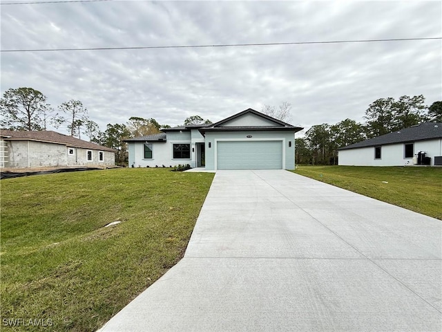 view of front of property featuring a garage and a front lawn