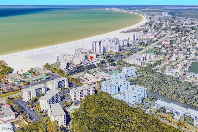 drone / aerial view featuring a water view and a beach view