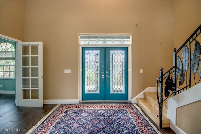 entryway with dark wood-type flooring and french doors