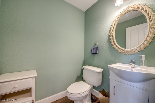 bathroom featuring toilet and vanity