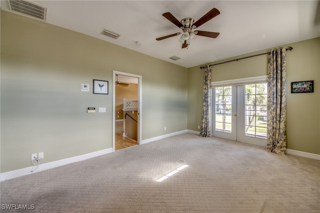 unfurnished room featuring ceiling fan, light carpet, and french doors