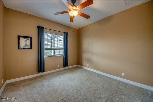 spare room with light colored carpet and ceiling fan