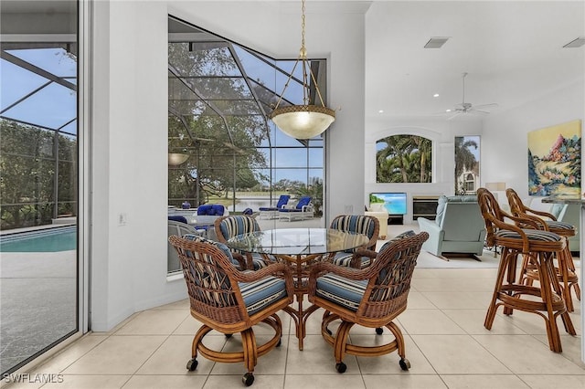 tiled dining space featuring ceiling fan