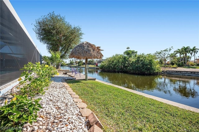 dock area with a yard and a water view