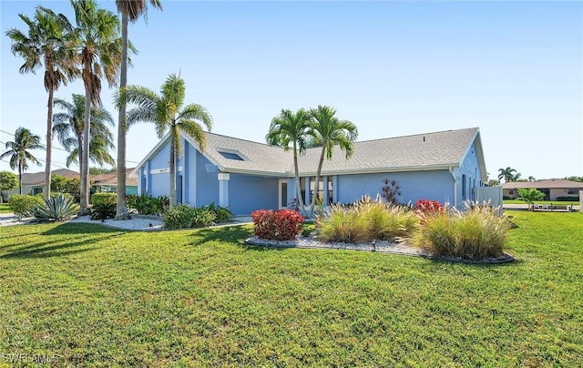 ranch-style home featuring a front yard