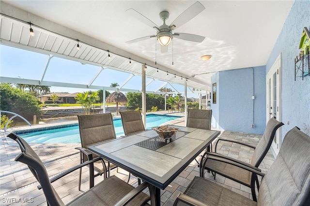 view of patio / terrace with ceiling fan and glass enclosure