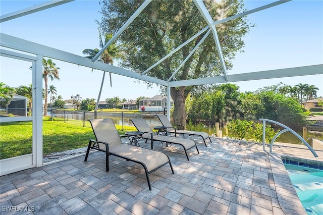 sunroom / solarium featuring a water view