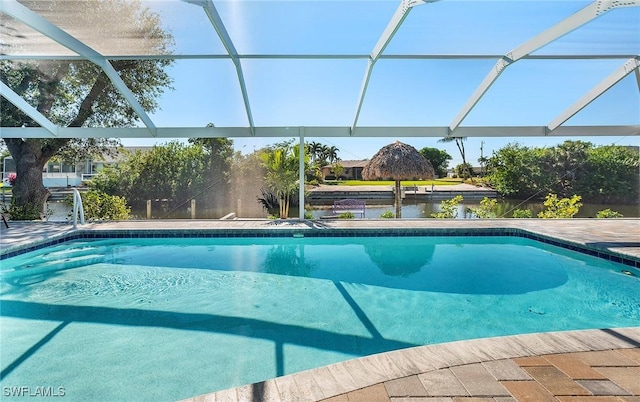 view of pool featuring a lanai and a water view