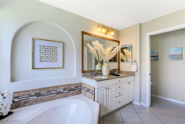 bathroom featuring vanity, tile patterned floors, and a bath