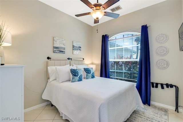 tiled bedroom featuring ceiling fan