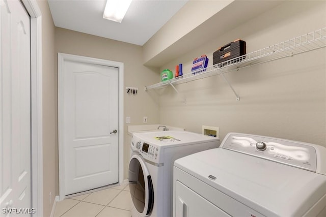 laundry room with light tile patterned flooring and independent washer and dryer