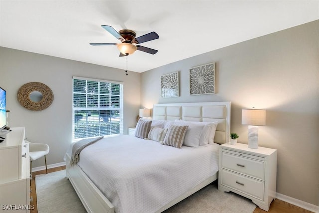 bedroom with ceiling fan and light hardwood / wood-style flooring