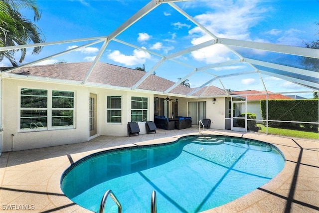 view of swimming pool with a lanai and a patio