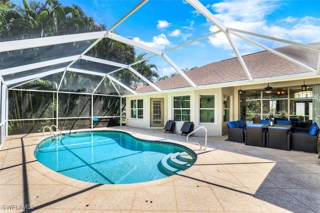 view of pool featuring ceiling fan, glass enclosure, and a patio