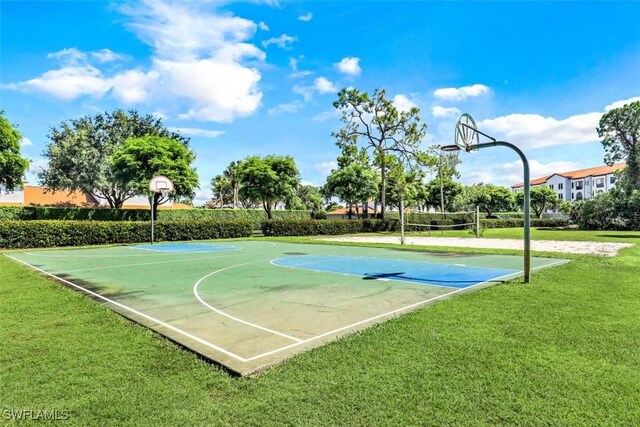 view of sport court featuring a lawn and volleyball court