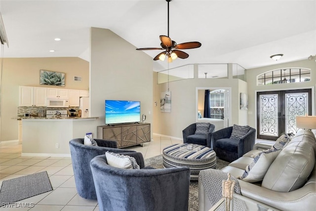 living room featuring lofted ceiling, ceiling fan, light tile patterned flooring, and french doors