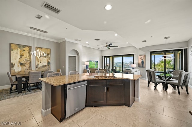 kitchen featuring stainless steel dishwasher, a center island with sink, sink, and hanging light fixtures