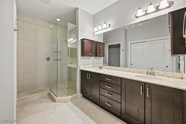 bathroom with tile patterned flooring, vanity, and a shower with shower door