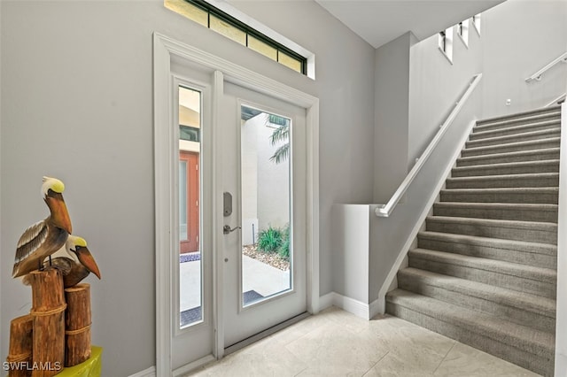 doorway to outside with light tile patterned floors