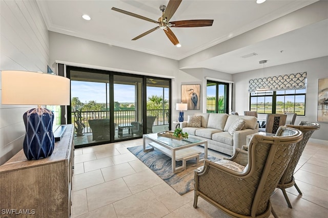 living room featuring ornamental molding, light tile patterned flooring, and ceiling fan