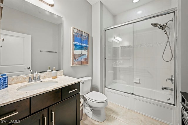 full bathroom with toilet, tile patterned flooring, combined bath / shower with glass door, and vanity