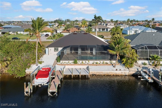 view of dock featuring boat lift, a residential view, a water view, a lanai, and a swimming pool