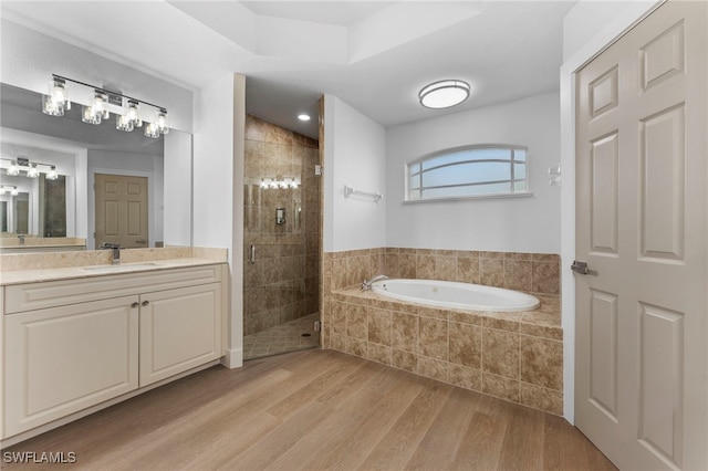 full bathroom with vanity, a stall shower, wood finished floors, and a bath