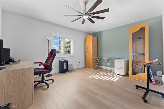 office with light wood-type flooring, a ceiling fan, and baseboards