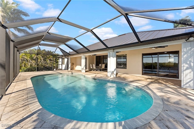 pool featuring ceiling fan, a patio, and glass enclosure