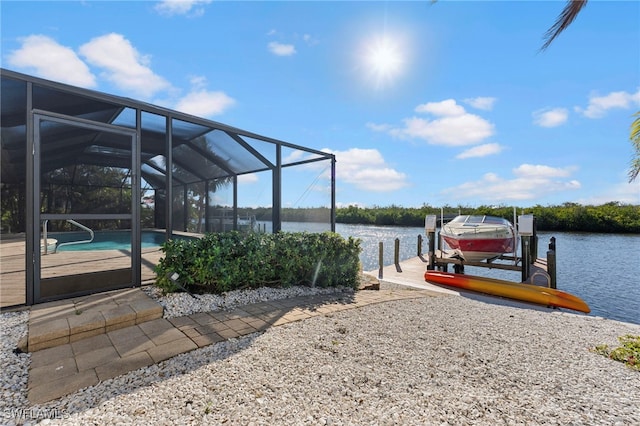 view of dock featuring glass enclosure, an outdoor pool, boat lift, and a water view