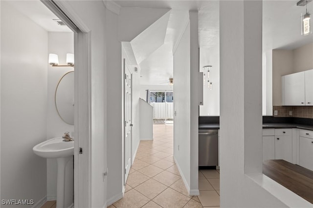 bathroom with sink, tile patterned flooring, ceiling fan, and tasteful backsplash