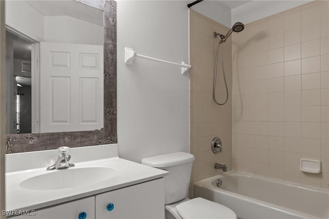 full bathroom featuring toilet, vanity, and tiled shower / bath combo