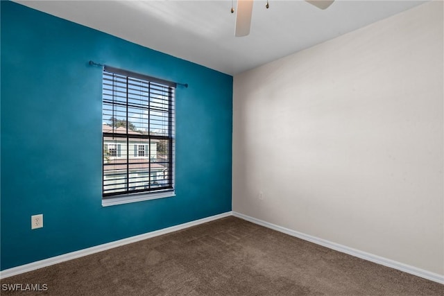 spare room featuring ceiling fan and carpet